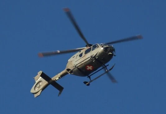 Helicopter in flight over mountains